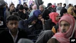 FILE - Hundreds of Syrian families wait to register at the United Nations High Commissioner for Refugees (UNHCR) headquarters in Beirut, Lebanon.