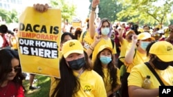 FILE - Susana Lujano, left, who was born in Mexico but lives in Houston, joins other activists to rally in support of the Deferred Action for Childhood Arrivals program, also known as DACA, at the U.S. Capitol in Washington, June 15, 2022.