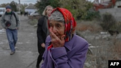 An woman cries in a street after a rocket attack in Mykolaiv, Oct. 23, 2022, during the Russian invasion of Ukraine.