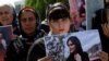  A woman holds a placard during a protest following the death of Mahsa Amini in front of the United Nations headquarters in Erbil, Iraq on September 24, 2022. (Azad Lashkari/Reuters)
