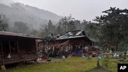 Debris are scattered around destroyed wooden structures near Aung Bar Lay Village, Hpakant township, Kachin state in Myanmar, Oct. 24, 2022