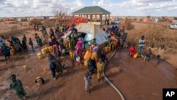 Water is distributed at a camp for displaced people on the outskirts of Dollow, Somalia, Sept. 20, 2022.