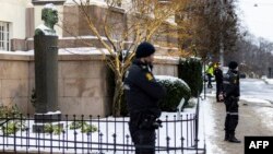 FILE - Police stands guard at the entrance of the Norwegian Nobel Institute prior to the arrivals of peace prize laureates Dmitry Muratov and Maria Ressa on Dec. 9, 2021 in Oslo ahead of the ceremony to present them with the award.