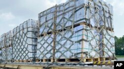 In this handout photo released by Pakistan Foreign Ministry Press Service, Local workers unload relief, sent by US government to Pakistani people from a U.S Air force plane at Noor Khan Air Base, in Islamabad, Sept. 9, 2022. (Pakistan Foreign Ministry Pr