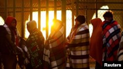 FILE - Venezuelan migrants, some expelled from the U.S. to Mexico under Title 42, queue outside of the National Migration Institute to process a permit to stay in Mexico for 180 days, in Ciudad Juarez, Mexico, Oct. 24, 2022. 