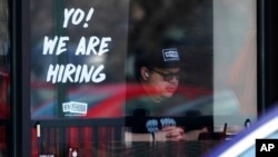 FILE - A hiring sign is displayed at a restaurant in Schaumburg, Ill., April 1, 2022. 