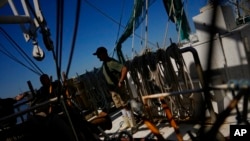 Crew prepare two less-damaged shrimp boats to get back out on the water, after most of the fleet at Erickson & Jensen Seafood was heavily damaged by Hurricane Ian, on San Carlos Island in Fort Myers Beach, Fla., Oct. 7, 2022.