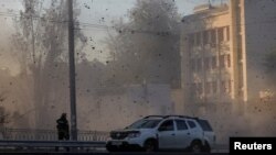 FILE - A view shows flying debris from an explosion in a street during a Russian drone strike, which local authorities consider to be Iranian-made Shahed-136 unmanned aerial vehicles (UAVs), in Kyiv, Ukraine, Oct. 17, 2022. 