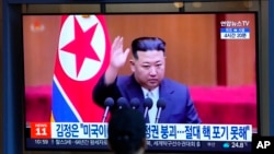 FILE - A man watches a TV screen showing a news program reporting with file footage of North Korean leader Kim Jong Un, at the Seoul Railway Station in Seoul, South Korea, Sept. 9, 2022.