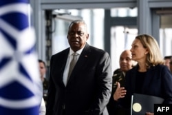 U.S. Defense Secretary Lloyd Austin and U.S. Permanent Representative to NATO Julianne Smith arrive for a two-day meeting of the alliance's defense ministers at NATO headquarter in Brussels, Oct. 12, 2022.