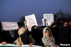 FILE - Muslim women take part in a protest organized by All India Majlis-e-Ittehadul Muslimeen (AIMM) against the recent hijab ban in few colleges of Karnataka state, at Shaheen Bagh in New Delhi, India, Feb. 9, 2022.