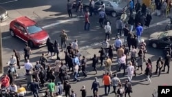 In this frame grab from video taken by an individual not employed by the Associated Press and obtained by the AP outside Iran shows people block an intersection during a protest to mark 40 days since the death of Mahsa Amini, in Tehran, Oct. 26, 2022. 