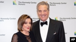 FILE - Speaker of the House Nancy Pelosi and her husband, Paul Pelosi, are seen at the State Department for the Kennedy Center Honors State Department Dinner, Dec. 7, 2019, in Washington. 