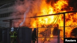 FILE - Firefighters work to put out a fire in a thermal power plant, damaged by a Russian missile strike in Kyiv, Oct. 18, 2022. (State Emergency Service of Ukraine/Handout via Reuters)