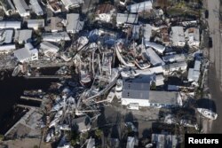 FILE - An aerial view of damaged boats and property after Hurricane Ian caused widespread destruction in Fort Myers, Florida, Sept. 30, 2022.