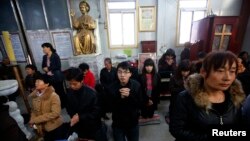 Believers take part in a weekend mass at an underground Catholic church in Tianjin, November 10, 2013. 