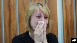 Anna, the aunt of the 4-year-old girl named Liza who was killed girl during Russian shelling on Thursday, cries as she waits for her injured sister at an intensive care unit of a hospital in Vinnytsia, Ukraine, July 15, 2022.
