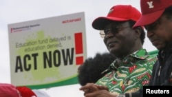 Nigeria Labour Congress President Ayuba Wabba stands next to a poster during an NLC protest over the closure of Nigerian universities at the National Assembly complex in Abuja, Nigeria July 27, 2022.