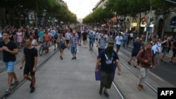 People take part in a rally under the motto "Stand for victims of Orban's government" against the new taxation rules near the Margaret Bridge in Budapest, July 16, 2022.