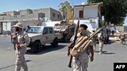 Members of the "444 Brigade" affiliated with Libya's Ministry of Defence man positions in the area of an overnight gunbattle in Tripoli's suburb of Ain Zara, on July 22, 2022.