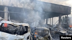 Destroyed vehicles are seen at the site of a Russian military strike in Vinnytsia, Ukraine July 14, 2022. (Press service of the State Emergency Service of Ukraine/Handout via Reuters) 