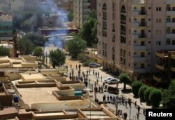 Riot police fire tear gas to disperse Sudanese demonstrators during a protest against Sudanese President Omar al-Bashir's rule in Khartoum, April 6, 2019.