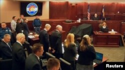 James Holmes (2nd L) stands at the start of his trial in Arapahoe County District Court in Centennial, Colorado in this still image captured from a pool video footage, April 27, 2015.