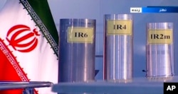 FILE - Three versions of domestically-built centrifuges are shown in a live TV program from Natanz, an Iranian uranium enrichment plant, in Iran, in this June 6, 2018, frame grab from the Islamic Republic Iran Broadcasting state-run TV.