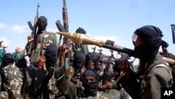 FILE - Armed al-Shabab fighters prepare to travel into the city, just outside the capital of Mogadishu, Somalia, Dec. 8, 2008. Somalia is pushing to have an arms embargo lifted in order to better fight the extremists. The U.N. Security Council is set to vote in November 2022.