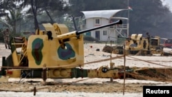 FILE - Soldiers stand next to anti-aircraft weapons on a beach near one of the venues of BRICS (Brazil, Russia, India, China and South Africa) Summit, in Cavelossim in the western state of Goa, India, Oct. 14, 2016.