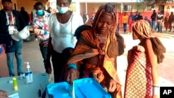 A voter casts her vote at a polling station in Luanda, Angola, Aug. 24, 2022. 