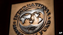 FILE - The logo of the International Monetary Fund on its building, April 5, 2021, in Washington. 