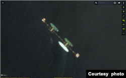 This satellite photo shows what TankerTrackers.com says is oil tanker Ephesos (northernmost of three pictured tankers) occupying a berth at Iraq's offshore Al-Basrah Oil Terminal on Aug. 10, 2022 (ESA)