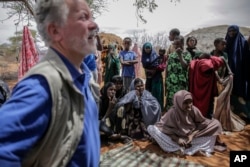 World Food Program chief David Beasley, left, meets with villagers in the village of Wagalla in northern Kenya Friday, Aug. 19, 2022. (AP Photo/Brian Inganga)