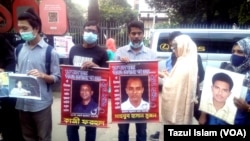 With photos of their relatives who disappeared after allegedly being picked up or abducted by security agencies, people formed a human chain at a rally in Dhaka on International Human Rights Day, Dec. 10, 2021. (Photo by Tazul Islam for VOA)