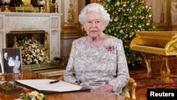 Britain's Queen Elizabeth poses, after recording her annual Christmas Day message, in the White Drawing Room of Buckingham Palace, London, in this undated picture released Dec. 24, 2018. 