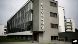 This June 27, 2017 photo shows the Bauhaus main building in Dessau, Germany. The Bauhaus World Heritage is to be extended to include the Houses with Balcony Access on the Dessau-Toerten housing estate and the ADGB Trade Union School.