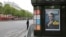 A police officer stands guard next to a newsstand displaying the cover of a news magazine depicting French president-elect Emmanuel Macron on the Champs Elyses avenue in Paris, France, May 8, 2017. 