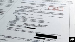 Documents related to the search warrant for former President Donald Trump's Mar-a-Lago estate in Palm Beach, Fla., are photographed, Aug. 18, 2022.