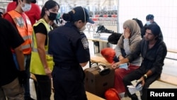 FILE - Afghan refugees are processed inside Hangar 5 at Ramstein Air Base in southwestern Germany, Sept. 8, 2021. 