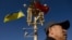 FILE - A man passes under a lamp post displaying Ukrainian and Chinese flags on Tiananmen Square in Beijing, China, Dec. 5, 2013. While Ukrainian President Volodymyr Zelenskyy has said that China has shown “neutrality” in his country's conflict with Russia, others beg to differ.