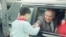 FILE - Soviet General Secretary Mikhail Gorbachev leans out of the window of his limousine to shake the hand of a Chinese child on hand to greet him as he arrived at Shanghai Airport on May 19, 1989, in Shanghai, China.