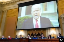 FILE - A video of President Donald Trump is shown on a screen, as the House select committee investigating the January 6 attack on the U.S. Capitol holds a hearing at the Capitol in Washington, July 21, 2022.