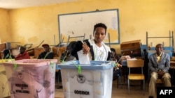 A woman casts her ballot at the Dandora secondary school polling station during Kenya's general election in Nairobi on Aug. 9, 2022.