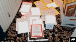 FILE - This image from a court filing by the Department of Justice on Aug. 30, 2022, and redacted by in part by the FBI, shows a photo of documents seized during the Aug. 8 search by the FBI of former President Donald Trump's Mar-a-Lago estate in Florida. 