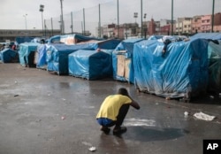 A sub-Saharan migrant washes at Ouled Ziane camp in Casablanca, Morocco, Dec. 6, 2018.