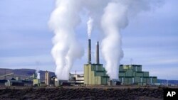 FILE - Steam and smoke billow from a coal-fired power plant in Craig, Colorado, Nov. 18, 2021.