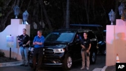 Armed Secret Service agents stand outside an entrance to former President Donald Trump's Mar-a-Lago estate, Aug. 8, 2022, in Palm Beach, Florida. 