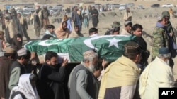 FILE - Relatives and local residents carry the coffin of a slain policeman, who was killed in an attack claimed by the Tehreek-e-Taliban Pakistan (TTP), during his funeral in the border town of Chaman, Jan. 28, 2022.