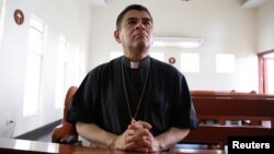FILE - Rolando Alvarez, bishop of the Diocese of Matagalpa and Esteli and critical of the Nicaraguan President Daniel Ortega, prays at a Catholic church where he was taking refuge prior to his imprisonment, in Managua, Nicaragua, May 20, 2022.